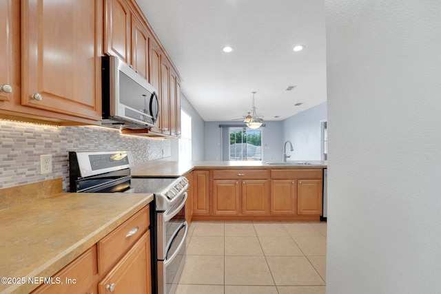 25122 Chipshot Ct, Sorrento, FL 32776 - kitchen featuring appliances with stainless steel finishes, tasteful backsplash, light countertops, light tile patterned flooring, and ceiling fan