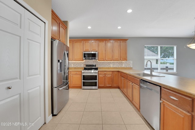 25122 Chipshot Ct, Sorrento, FL 32776 - kitchen featuring stainless steel appliances, backsplash, light tile patterned floors, light countertops, and recessed lighting