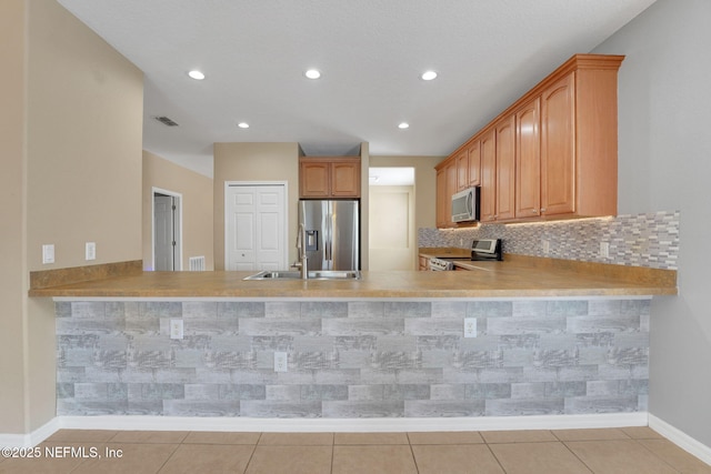 25122 Chipshot Ct, Sorrento, FL 32776 - kitchen with appliances with stainless steel finishes, a peninsula, light countertops, light tile patterned floors, and recessed lighting