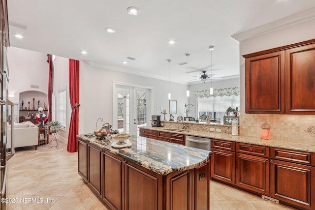 2645 Oakgrove Ave, Saint Augustine, FL 32092 - kitchen with light tile patterned floors, light stone countertops, a center island, ceiling fan, and stainless steel dishwasher