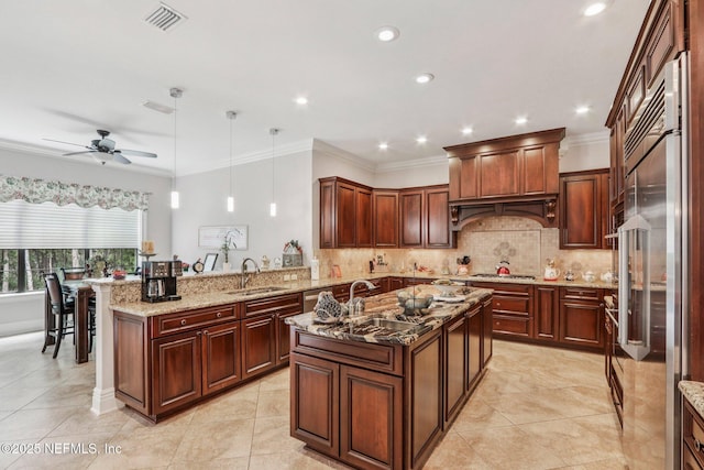 2645 Oakgrove Ave, Saint Augustine, FL 32092 - kitchen featuring appliances with stainless steel finishes, backsplash, a peninsula, a ceiling fan, and light stone countertops