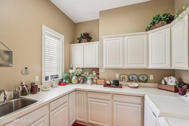 2645 Oakgrove Ave, Saint Augustine, FL 32092 - kitchen featuring independent washer and dryer, white cabinetry, and light countertops