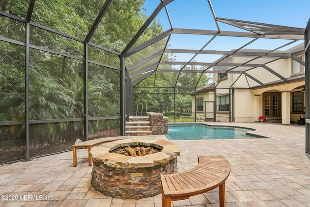 2645 Oakgrove Ave, Saint Augustine, FL 32092 - swimming pool featuring a patio area, an outdoor fire pit, and a lanai