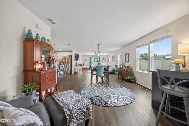 2069 Denton Trce, Green Cove Springs, FL 32043 - living room with wood finished floors, a chandelier, and a textured ceiling
