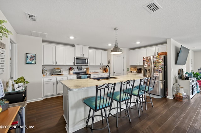2069 Denton Trce, Green Cove Springs, FL 32043 - kitchen with stainless steel appliances, dark wood-type flooring, light countertops, white cabinets, and recessed lighting