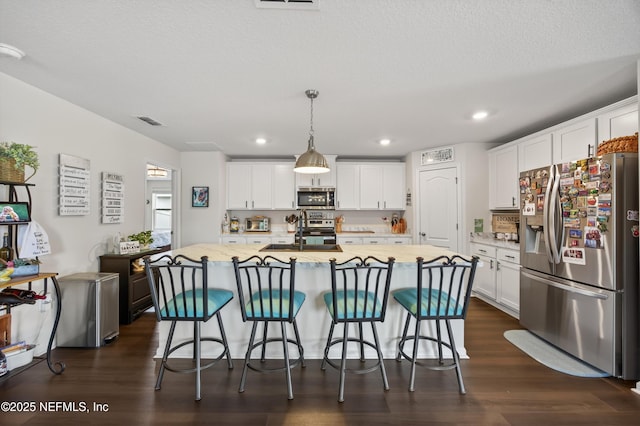 2069 Denton Trce, Green Cove Springs, FL 32043 - kitchen featuring appliances with stainless steel finishes, light countertops, dark wood-style flooring, white cabinets, and recessed lighting