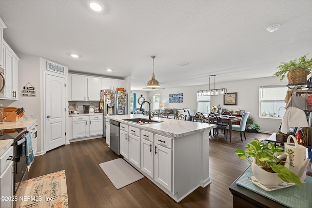 2069 Denton Trce, Green Cove Springs, FL 32043 - kitchen with black range with electric cooktop, dark wood finished floors, white cabinets, pendant lighting, and recessed lighting