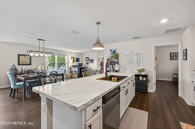 2069 Denton Trce, Green Cove Springs, FL 32043 - kitchen featuring dishwasher, white cabinets, dark wood-style flooring, pendant lighting, and a kitchen island with sink