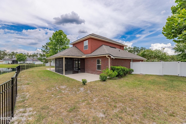1300 Coopers Hawk Way, Middleburg, FL 32068 - back of house with a sunroom, a patio, brick siding, and a fenced backyard