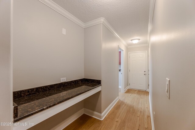 1300 Coopers Hawk Way, Middleburg, FL 32068 - corridor featuring crown molding, light wood-style flooring, a textured ceiling, and a desk