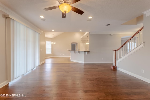 1300 Coopers Hawk Way, Middleburg, FL 32068 - unfurnished living room featuring a chandelier, wood finished floors, stairway, a ceiling fan, and crown molding