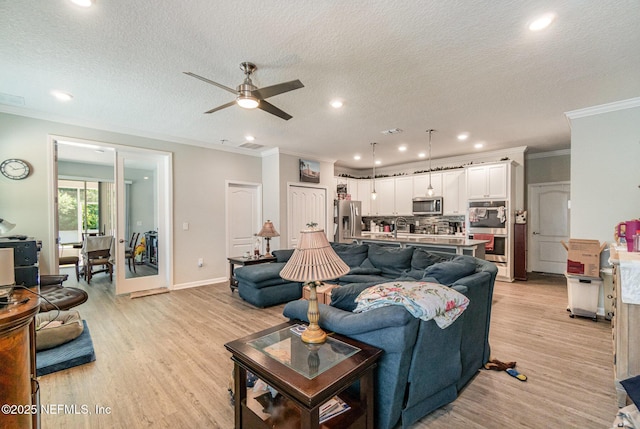22 Sandstone Dr, Saint Augustine, FL 32086 - living area featuring ornamental molding, light wood finished floors, ceiling fan, recessed lighting, and a textured ceiling