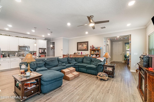 22 Sandstone Dr, Saint Augustine, FL 32086 - living area with light wood-style flooring, a ceiling fan, recessed lighting, ornamental molding, and a textured ceiling