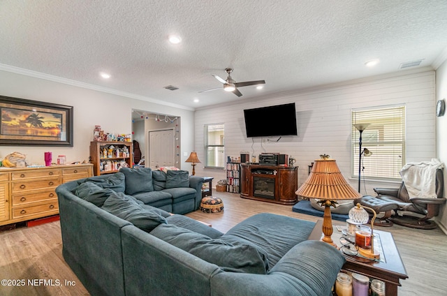 22 Sandstone Dr, Saint Augustine, FL 32086 - living room with a textured ceiling, a ceiling fan, light wood finished floors, crown molding, and recessed lighting