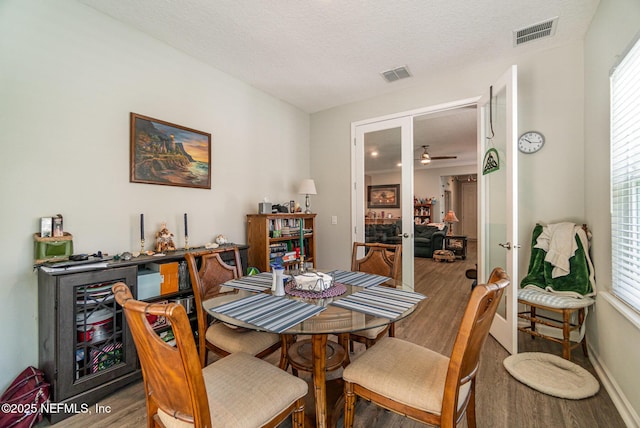 22 Sandstone Dr, Saint Augustine, FL 32086 - dining area featuring wood finished floors, plenty of natural light, ceiling fan, a textured ceiling, and french doors