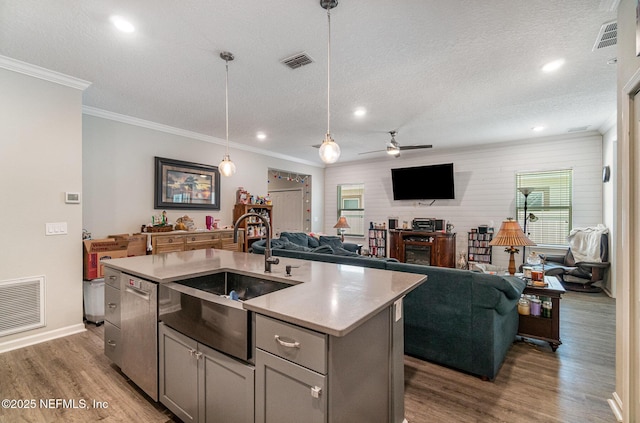 22 Sandstone Dr, Saint Augustine, FL 32086 - kitchen featuring ceiling fan, a fireplace, light wood-type flooring, open floor plan, and ornamental molding