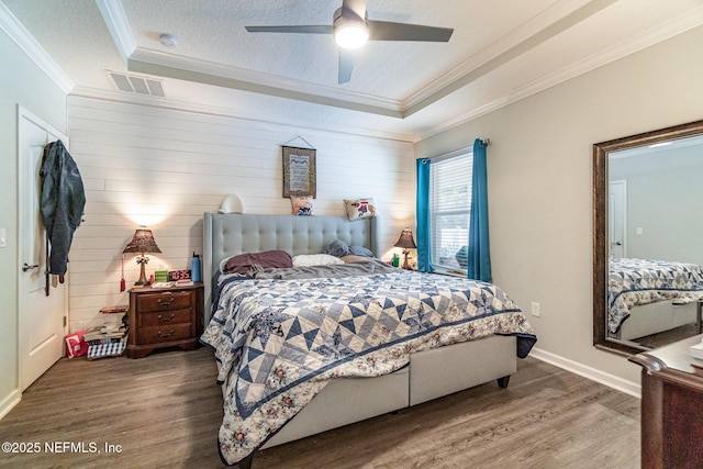 22 Sandstone Dr, Saint Augustine, FL 32086 - bedroom featuring crown molding, wood finished floors, a textured ceiling, a tray ceiling, and ceiling fan