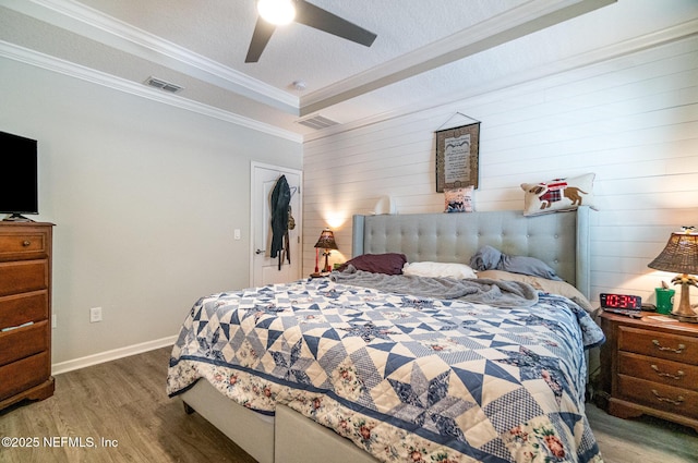 22 Sandstone Dr, Saint Augustine, FL 32086 - bedroom with wood finished floors, crown molding, a ceiling fan, and wooden walls