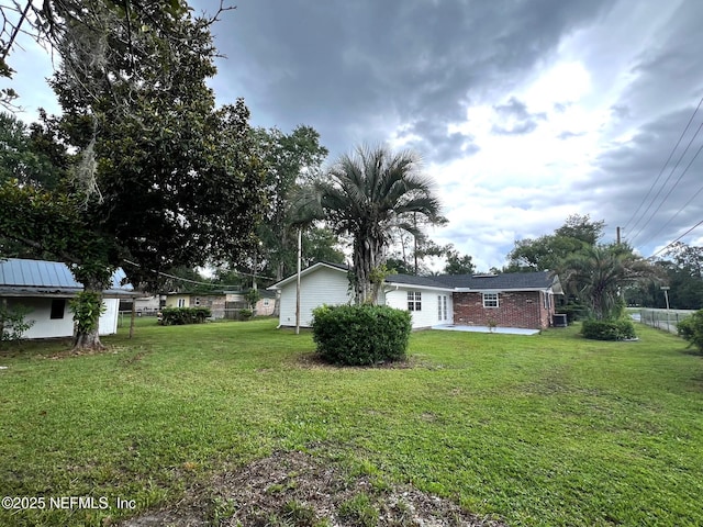523 Eloise St, Macclenny, FL 32063 - view of green lawn with a patio area