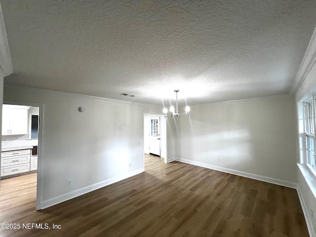 523 Eloise St, Macclenny, FL 32063 - spare room with a chandelier, wood finished floors, ornamental molding, and a textured ceiling