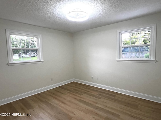 523 Eloise St, Macclenny, FL 32063 - unfurnished room featuring wood finished floors, plenty of natural light, and a textured ceiling