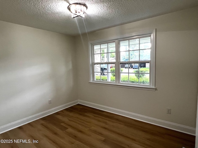 523 Eloise St, Macclenny, FL 32063 - unfurnished room with dark wood-type flooring and a textured ceiling