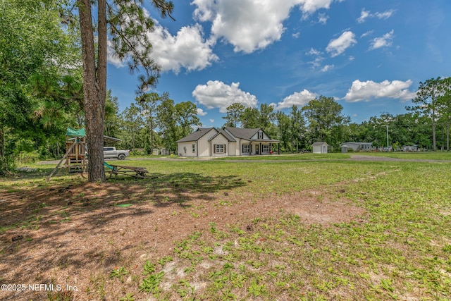 1926 Friendly Pl, Middleburg, FL 32068 - view of green lawn featuring a shed and a playground