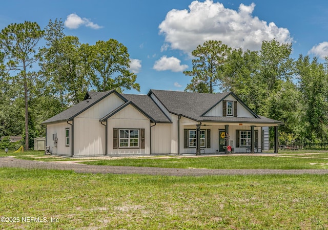 1926 Friendly Pl, Middleburg, FL 32068 - modern farmhouse style home featuring a porch, a front lawn, and a storage shed