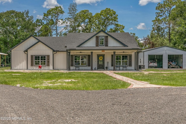 1926 Friendly Pl, Middleburg, FL 32068 - modern farmhouse featuring a front lawn, a porch, ceiling fan, a shingled roof, and an outbuilding