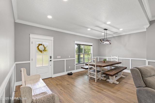 1926 Friendly Pl, Middleburg, FL 32068 - dining space with ornamental molding, wood finished floors, recessed lighting, and a textured ceiling