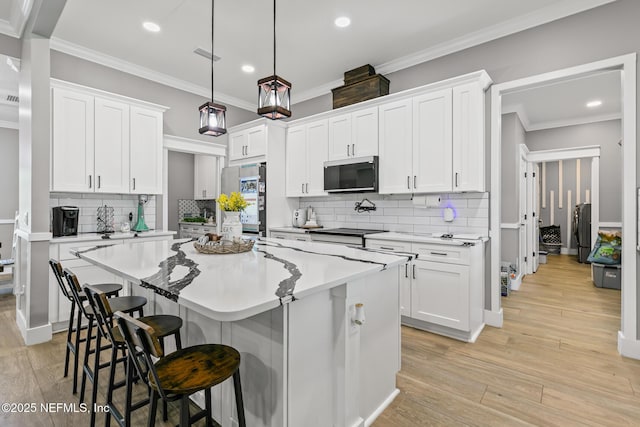 1926 Friendly Pl, Middleburg, FL 32068 - kitchen featuring stainless steel refrigerator, a breakfast bar area, white cabinets, recessed lighting, and tasteful backsplash