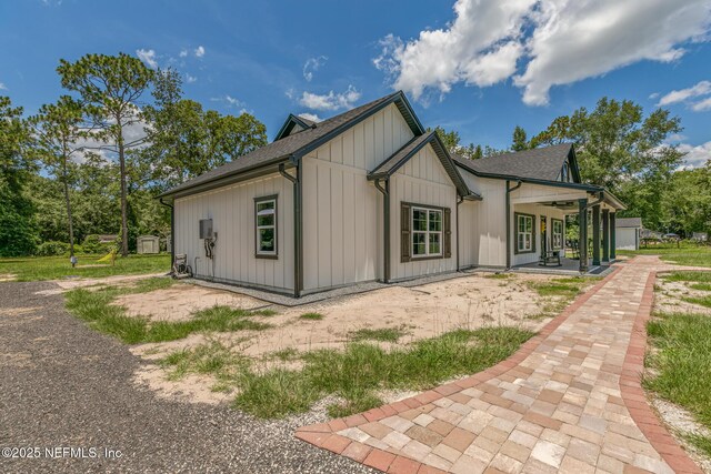 1926 Friendly Pl, Middleburg, FL 32068 - rear view of property featuring a shingled roof and board and batten siding