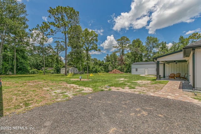 1926 Friendly Pl, Middleburg, FL 32068 - view of grassy yard with a shed, ceiling fan, and a patio area