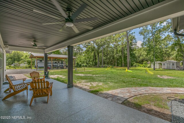 1926 Friendly Pl, Middleburg, FL 32068 - view of patio featuring a ceiling fan, a storage shed, and view of wooded area