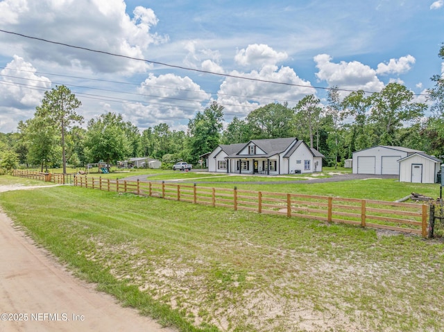 1926 Friendly Pl, Middleburg, FL 32068 - view of front facade with a garage, an outdoor structure, a view of countryside, and view of scattered trees