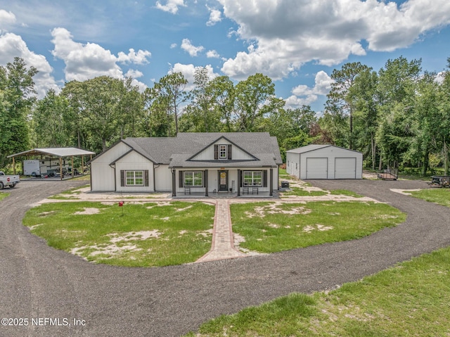 1926 Friendly Pl, Middleburg, FL 32068 - view of front of house with covered porch, an outbuilding, a detached garage, a front lawn, and a detached carport