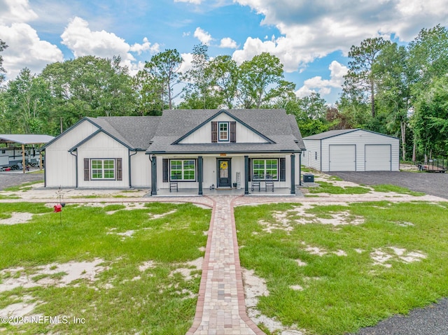 1926 Friendly Pl, Middleburg, FL 32068 - modern farmhouse style home featuring covered porch, an outbuilding, a detached garage, and a front lawn