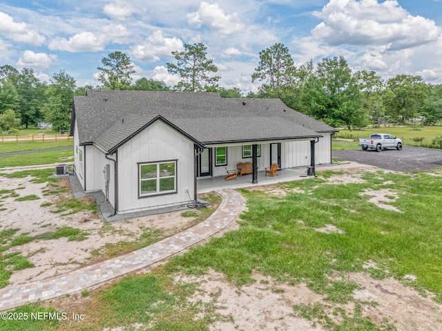 1926 Friendly Pl, Middleburg, FL 32068 - back of property featuring roof with shingles, a yard, board and batten siding, and a patio