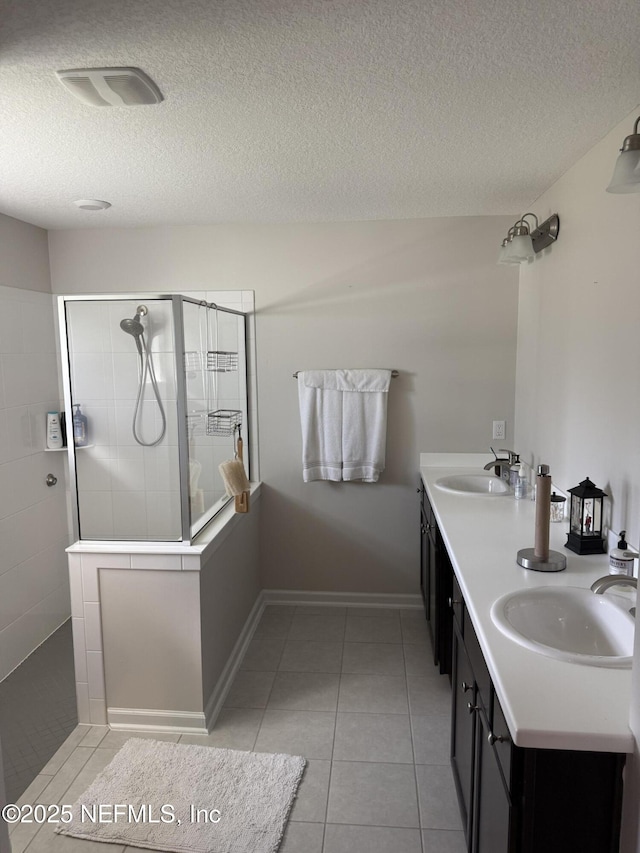 30139 Trophy Trl, Bryceville, FL 32009 - bathroom featuring a walk in shower, a textured ceiling, tile patterned floors, and double vanity