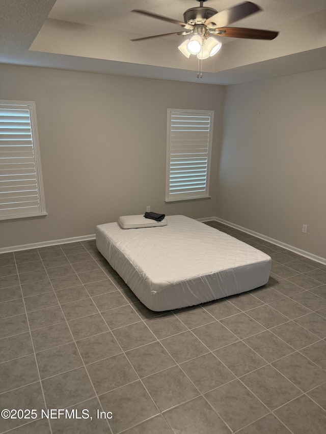 30139 Trophy Trl, Bryceville, FL 32009 - bedroom with dark tile patterned flooring, multiple windows, and ceiling fan