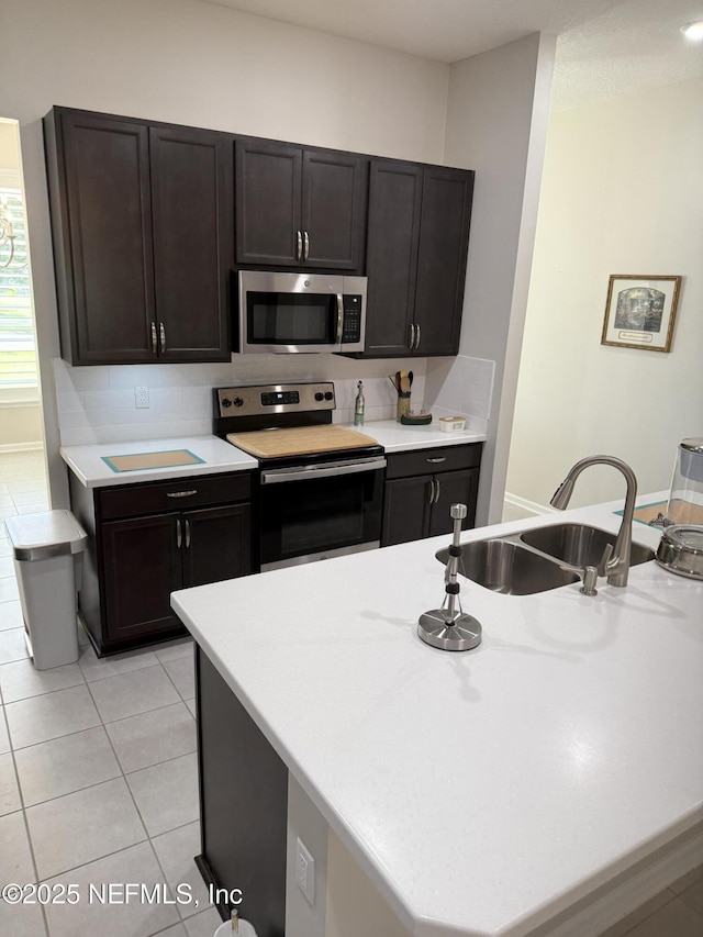 30139 Trophy Trl, Bryceville, FL 32009 - kitchen featuring stainless steel appliances, light countertops, light tile patterned floors, and backsplash