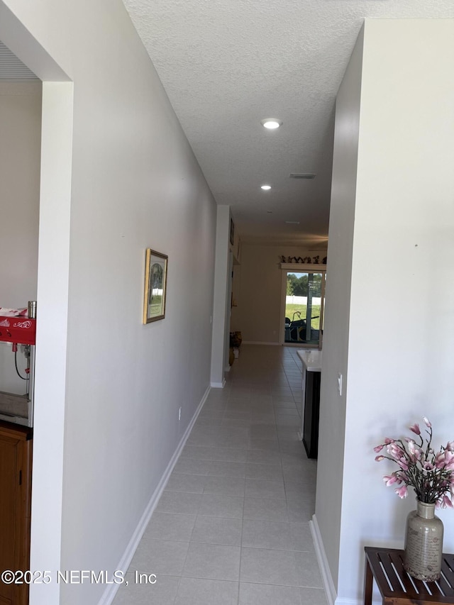 30139 Trophy Trl, Bryceville, FL 32009 - corridor with light tile patterned floors, recessed lighting, and a textured ceiling