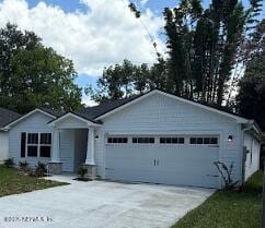 3138 Phyllis St, Jacksonville, FL 32205 - ranch-style house featuring an attached garage and concrete driveway