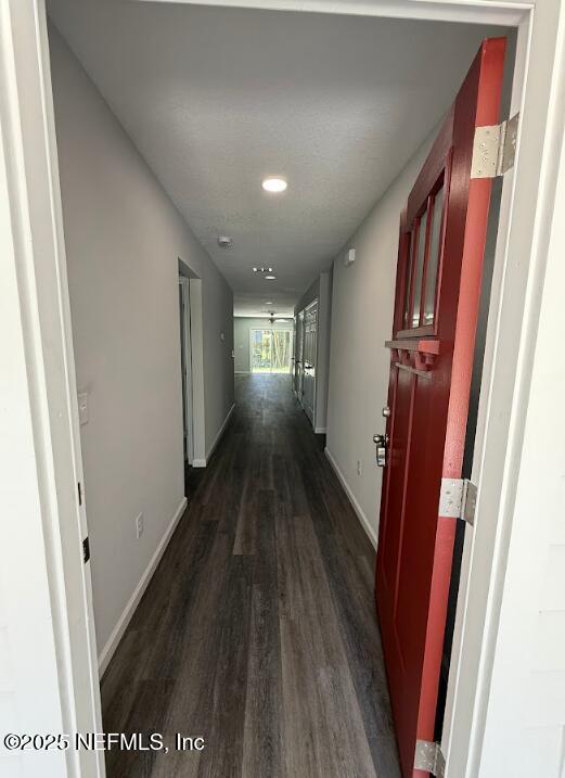 3138 Phyllis St, Jacksonville, FL 32205 - hallway featuring dark wood-style flooring and baseboards