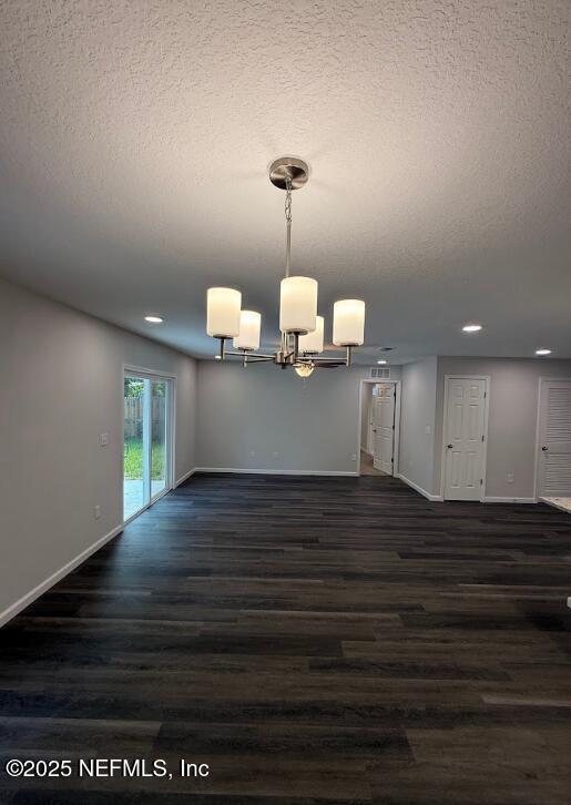 3138 Phyllis St, Jacksonville, FL 32205 - spare room featuring a textured ceiling, a chandelier, dark wood-style flooring, and recessed lighting