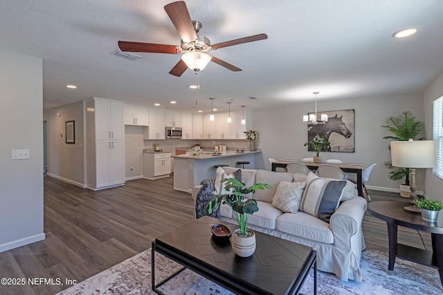 3138 Phyllis St, Jacksonville, FL 32205 - living area featuring ceiling fan, dark wood-type flooring, a chandelier, recessed lighting, and a textured ceiling