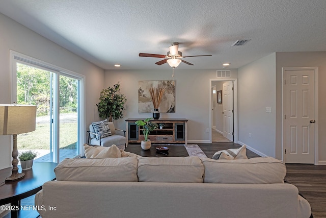 3138 Phyllis St, Jacksonville, FL 32205 - living room featuring dark wood finished floors, a ceiling fan, a textured ceiling, and recessed lighting