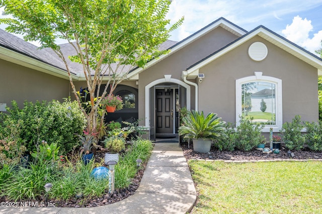 338 Deerfield Glen Dr, Saint Augustine, FL 32086 - view of front facade with stucco siding and a front lawn