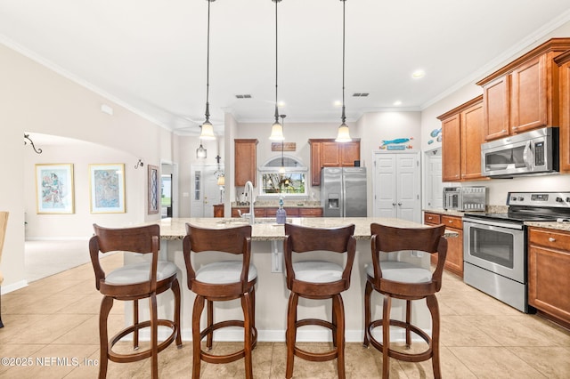 338 Deerfield Glen Dr, Saint Augustine, FL 32086 - kitchen with appliances with stainless steel finishes, brown cabinetry, crown molding, light tile patterned floors, and recessed lighting