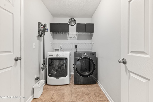 338 Deerfield Glen Dr, Saint Augustine, FL 32086 - laundry area featuring washer and clothes dryer, a textured ceiling, and light tile patterned floors